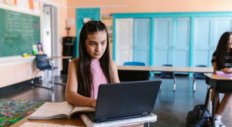 Student with a laptop in class