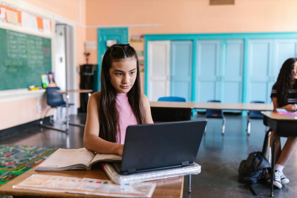 Student with a laptop in class