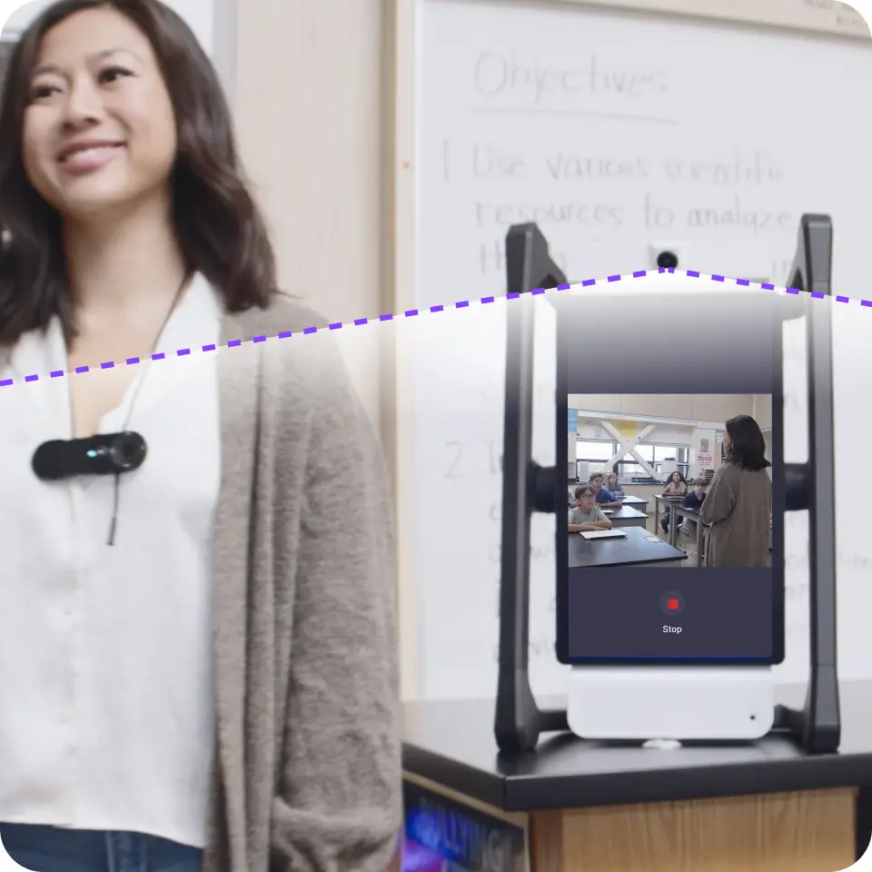 A teacher wearing a small clip-on camera standing next to an AI device that shows a live video feed of the classroom