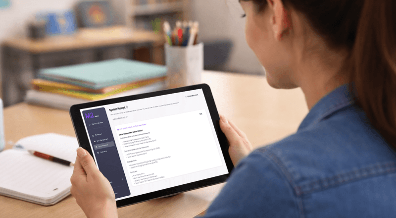Teacher reviewing M2 instructional feedback dashboard on a tablet in a classroom, over-the-shoulder view