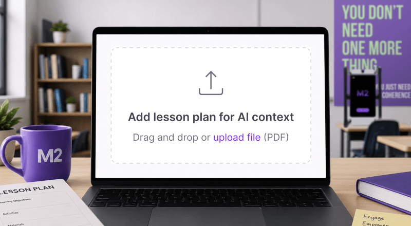 Laptop displaying the M2 lesson plan upload feature with a drag-and-drop upload area for lesson plans, surrounded by classroom materials and M2 branding in a modern classroom setting.