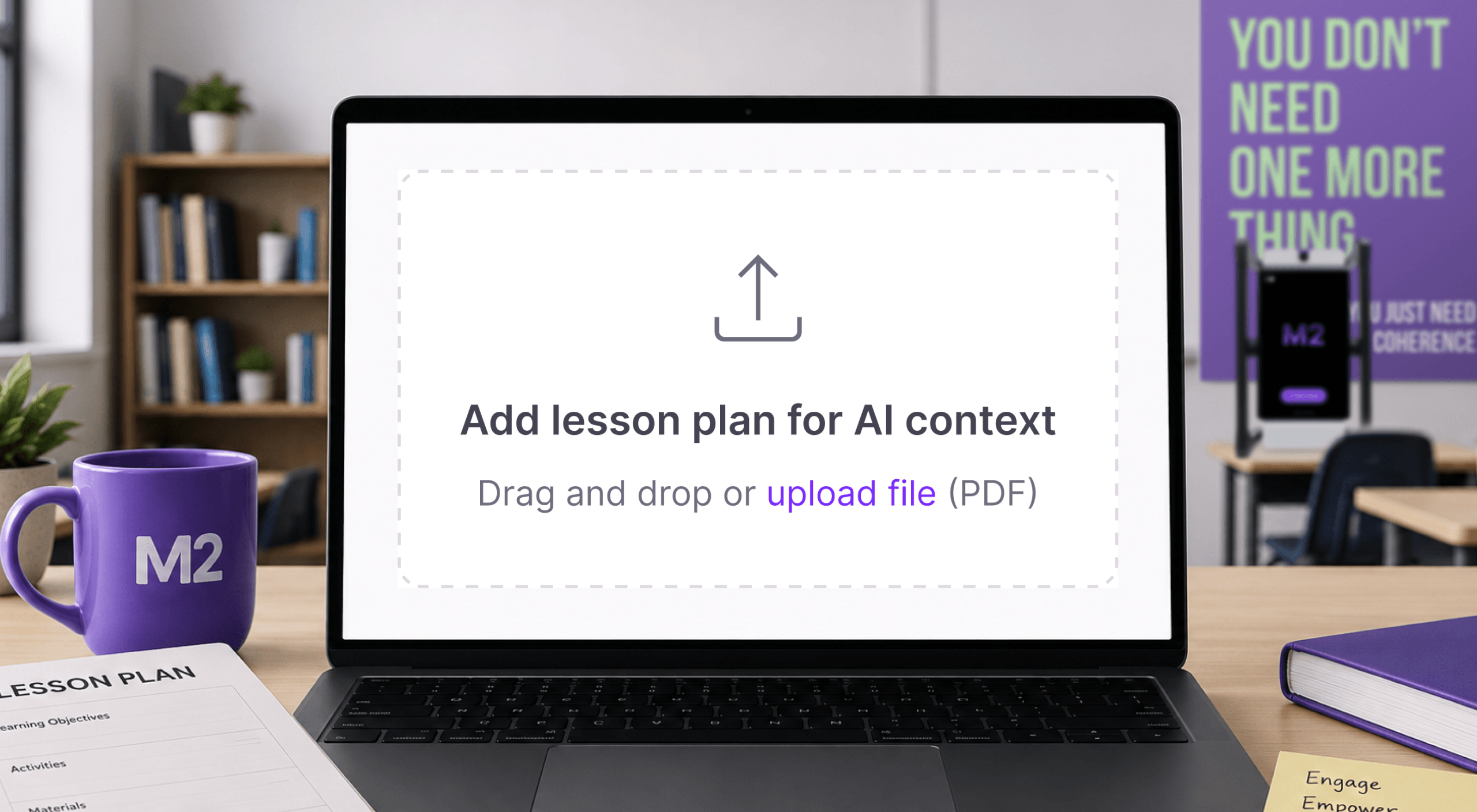 Laptop displaying the M2 lesson plan upload feature with a drag-and-drop upload area for lesson plans, surrounded by classroom materials and M2 branding in a modern classroom setting.